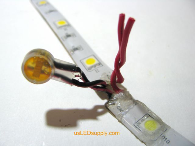 Single color flexible LED strips with black wires connected via butt (crimp) connector