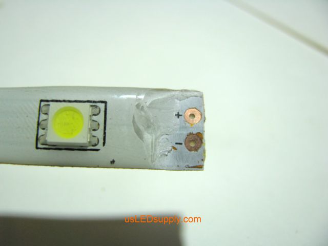 Single color flexible LED strip with coating peeled off and solder pads cleaned